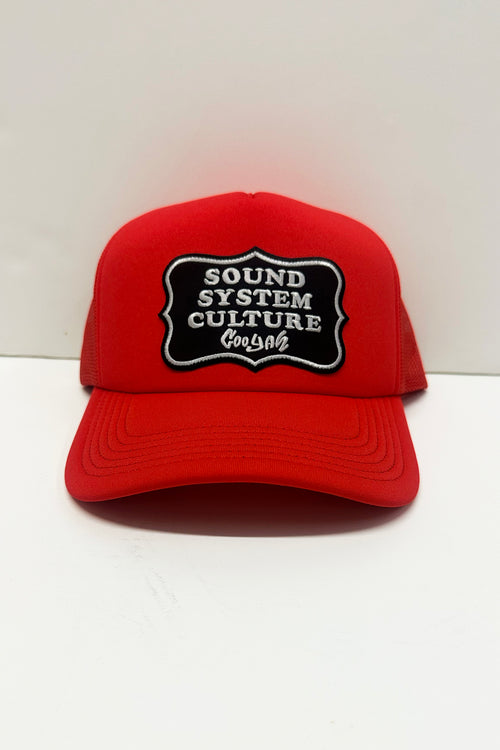 Red cap with 'Sound System Culture' patch on a white background