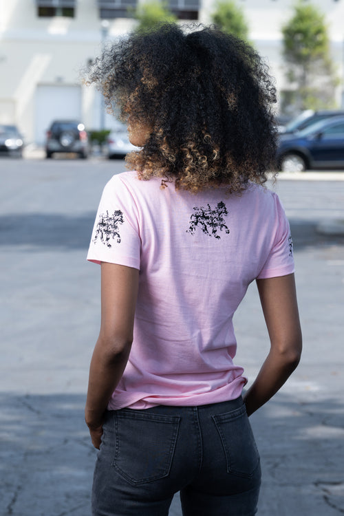 Cooyah rasta lion graphic tee. Women's light pink t-shirt with black lion graphics screen printed on the front and sleeves. Jamaican clothing brand.