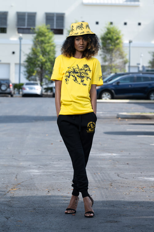 Cooyah Jamaica graphic tee with Rasta Lion. Yellow women's t-shirt with black lion graphics screen printed on the front and sleeves.