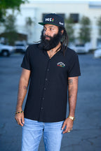 Men's black snapback hat with Yes I embroidered graphic in reggae colors.