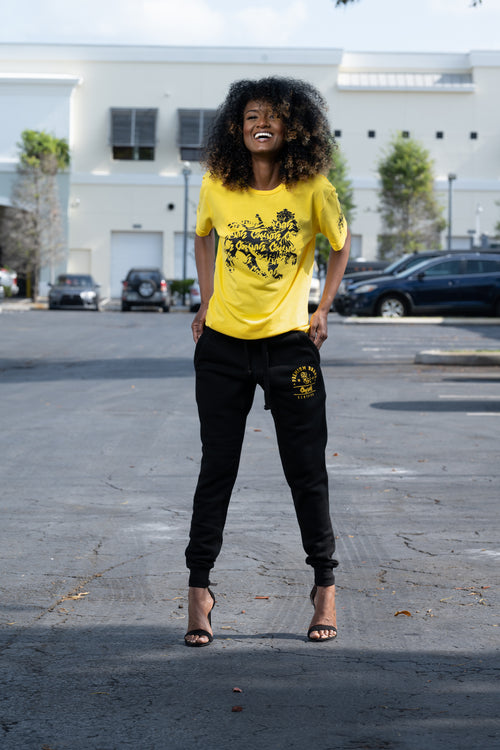 Cooyah Jamaica graphic tee with Rasta Lion. Yellow women's t-shirt with black lion graphics screen printed on the front and sleeves.