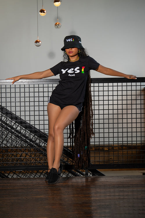 Cooyah Jamaica - Women's Yes I Graphic Tee and bucket hats.  Screen printed on soft 100% ringspun cotton.  Short sleeve, crew neck.  As a Jamaican owned clothing brand since 1987, we take pride in bringing you this classic shirt. Don't wait, get yours now!