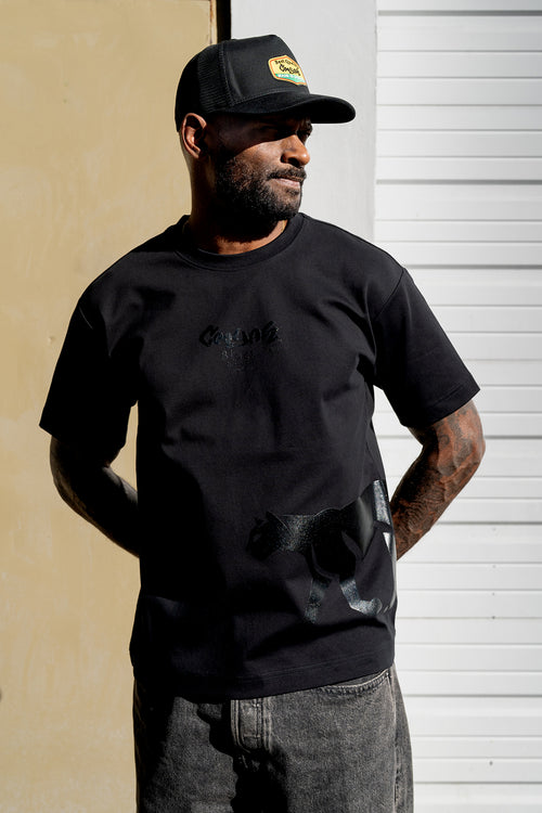 Minimalist black streetwear t-shirt featuring tonal panther graphic and Cooyah signature logo
