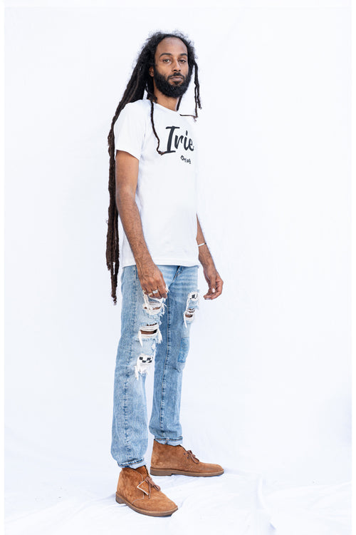 Cooyah Jamaica Irie Yard graphic tee in white. Men's crew neck, short sleeve t-shirt.   As a Jamaican owned clothing brand since 1987, we take pride in bringing you this classic piece. Don't wait, get yours now!