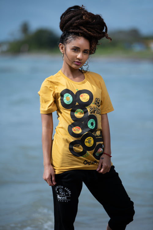 Cooyah Jamaica. Women's short sleeve graphic tee with 45 RPM Vinyl records screen printed on the front. Vintage reggae and rocksteady style. Mustard yellow boyfriend-fit Shirt, short sleeve, ringspun cotton. Jamaican streetwear clothing brand. IRIE