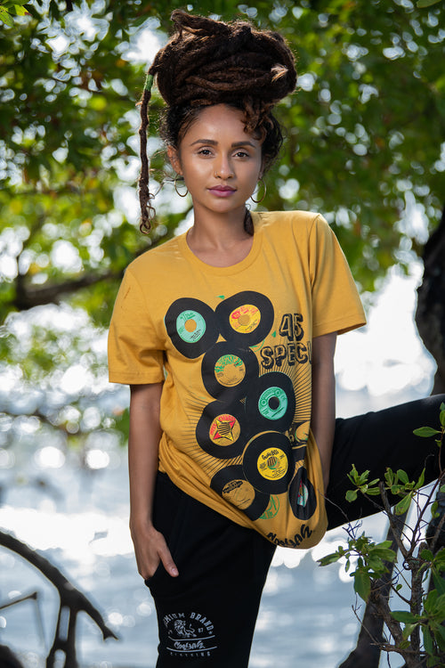 Cooyah Jamaica. Women's short sleeve graphic tee with 45 RPM Vinyl records screen printed on the front. Vintage reggae and rocksteady style. Mustard yellow boyfriend-fit Shirt, short sleeve, ringspun cotton. Jamaican streetwear clothing brand. IRIE