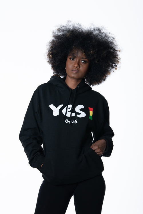 Cooyah Clothing. Women's Yes I Jamaica hoodie in black. Screen printed design in reggae colors. Jamaican streetwear clothing. IRIE