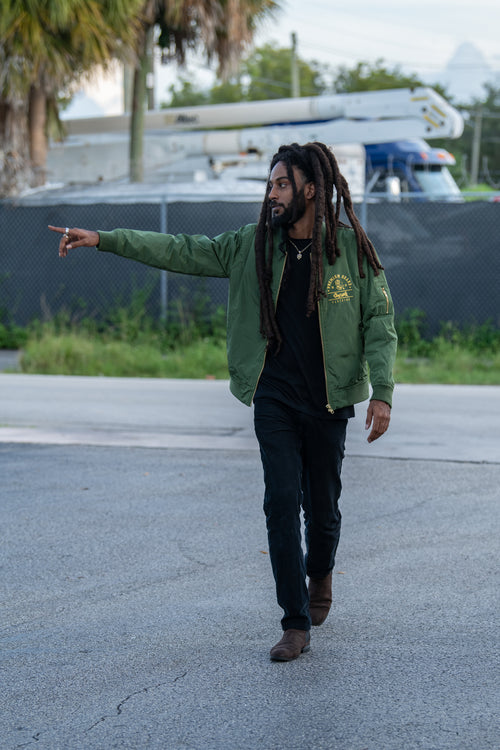 Cooyah Clothing - Men's Premium Brand Bomber reggae style Jacket with gold Lion print on olive green fabric. We are a Jamaican streetwear clothing brand established in 1987.  IRIE