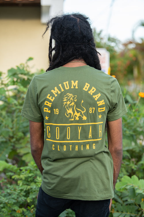 Cooyah Jamaica. Men's Premium Brand graphic tee. Gold Lion design screen printed on a black ringspun cotton t-shirt. Jamaican streetwear clothing brand.