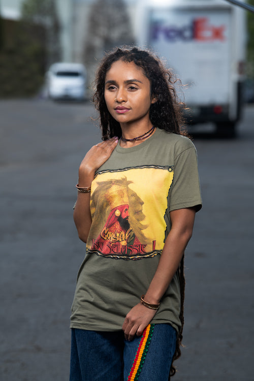 Cooyah Clothing. Women's Haile Selassie Rastafari Lion graphic tee in olive green. Crew neck, short sleeve, soft, ringspun cotton.  As a Jamaican owned clothing brand since 1987, we take pride in bringing you this classic rasta shirt.