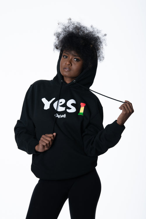 Cooyah Clothing. Women's Yes I Jamaica hoodie in black. Screen printed design in reggae colors. Jamaican streetwear clothing. IRIE