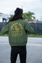 Load image into Gallery viewer, Cooyah Clothing. Men&#39;s Premium Brand Bomber Jacket with gold Lion print on olive green fabric. Jamaican streetwear clothing brand.
