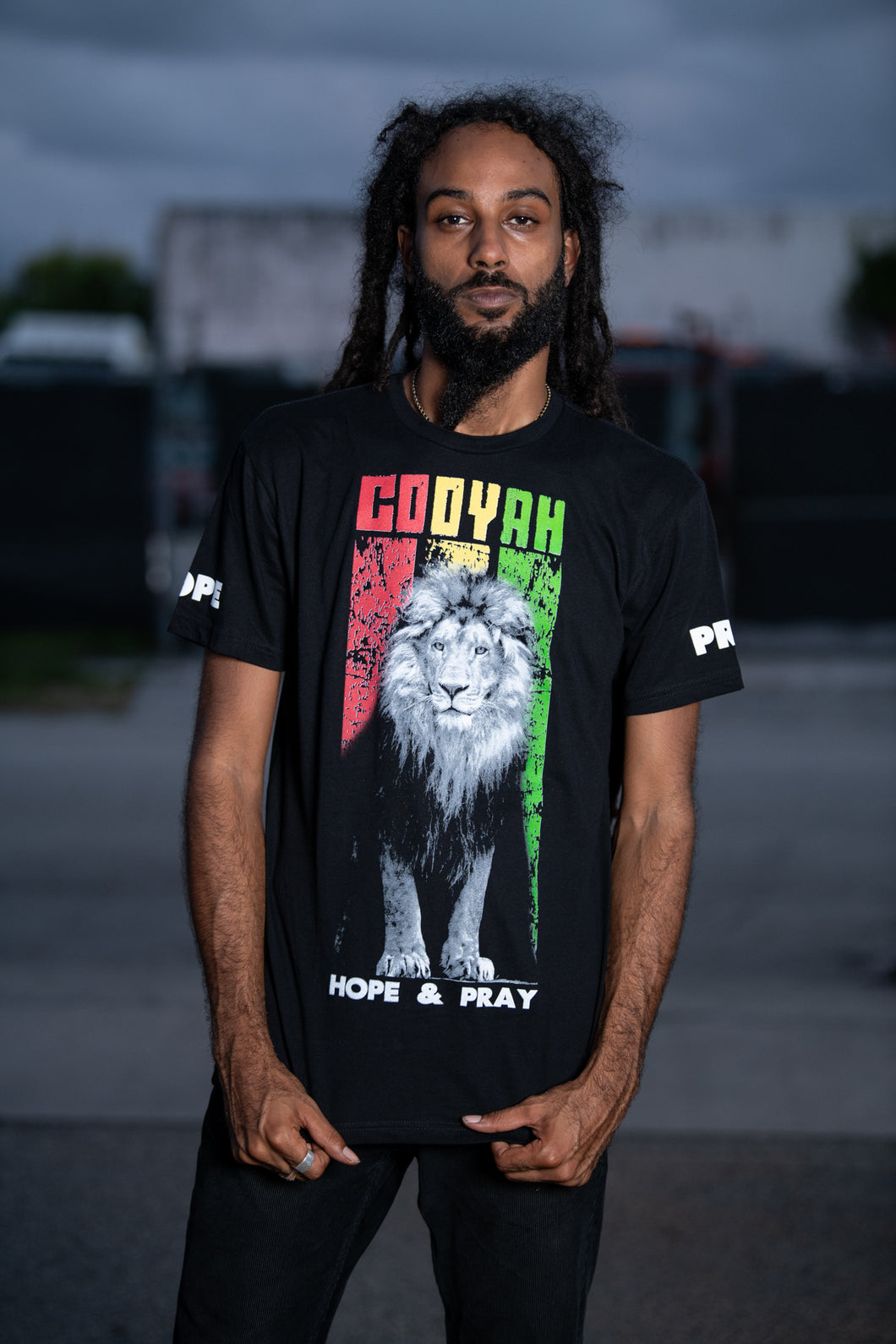 Cooyah Clothing. Rasta Lion men's short sleeve tee. Crew neck with reggae colors print and Hope and Pray design on the sleeves. Jamaican streetwear clothing.