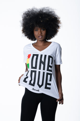 Cooyah Jamaica. One Love women's graphic tee in white. V-Neck, short sleeve, ringspun cotton screen printed in reggae colors. Jamaican clothing brand.