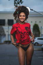 Load image into Gallery viewer, Cooyah Jamaica.  Women&#39;s relaxed fit Simmer Down T-Shirt featuring a Rastaman on a bicycle design.  Ring Spun Cotton, Short Sleeve Red Tee.  Jamaican streetwear clothing brand.
