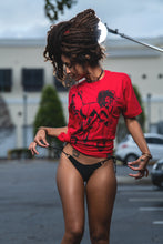 Load image into Gallery viewer, Cooyah Jamaica. Women&#39;s relaxed fit Simmer Down T-Shirt featuring a Rastaman on a bicycle design. Ring Spun Cotton, Short Sleeve Red Tee. Jamaican streetwear clothing brand.

