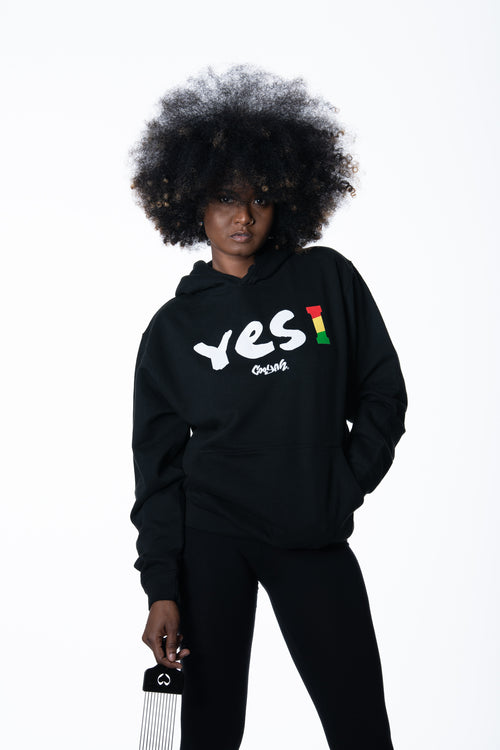 Cooyah Clothing. Women's Yes I Jamaica hoodie in black. Screen printed design in reggae colors. Jamaican streetwear clothing. IRIE