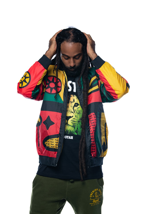 Male model in Afrocentric 90s-style Cooyah bomber jacket standing on white background